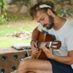 Arthur Playing Guitar at Vinyasa Earth